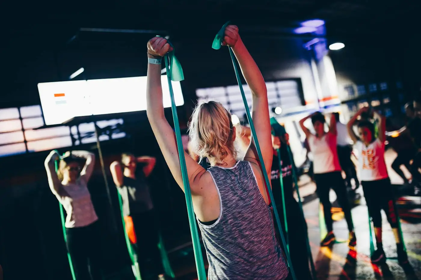 Group fitness class with arms raised